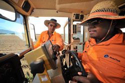 Indigenous trainee receiving instructions on grader operation